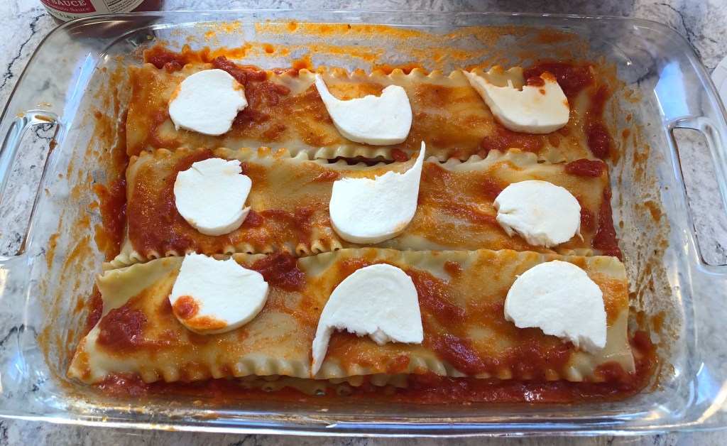 Picture of last layer of Lasagna with cheese.