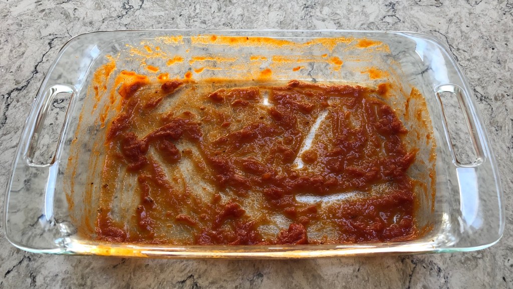 Picture of Lasagna Pan Coated with Marinara Sauce (Step 3)